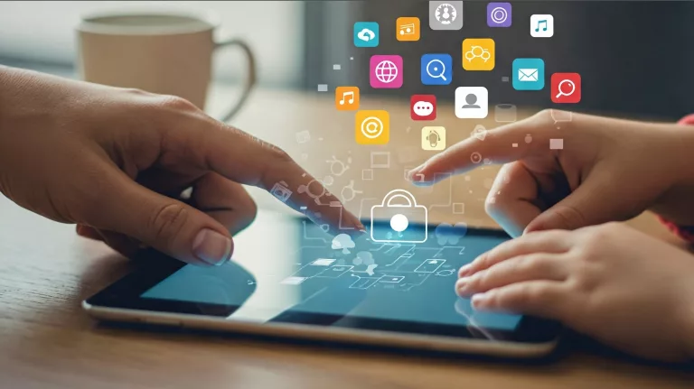 image of an adult and reaching for a childs hand over a tablet with icons floating above